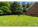Grassy backyard with brick house and access stairs at 112 Chasse Ct, Cleveland, NC 27013