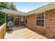 Back deck with brick siding and screened porch access at 112 Chasse Ct, Cleveland, NC 27013