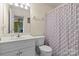 Well-maintained bathroom with white vanity and patterned shower curtain at 112 Chasse Ct, Cleveland, NC 27013