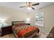 Bedroom with vibrant bedding, ceiling fan, carpeting, and a window for natural light at 112 Chasse Ct, Cleveland, NC 27013
