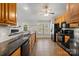 Traditional kitchen featuring wood cabinets, black countertops, tile flooring and stainless steel appliances at 112 Chasse Ct, Cleveland, NC 27013