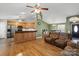 Open-concept living room with hardwood floors and views of the kitchen and dining areas at 112 Chasse Ct, Cleveland, NC 27013