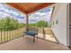 Covered back porch with wood ceiling, black railing, and comfortable bench seating at 1134 Fincher Rd, Fort Lawn, SC 29714