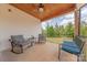 Covered back porch with ceiling fan, wood ceiling and comfortable seating with beautiful backyard views at 1134 Fincher Rd, Fort Lawn, SC 29714