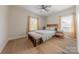 Comfortable bedroom with light walls, ceiling fan, light hardwood floors, and bench seat at 1134 Fincher Rd, Fort Lawn, SC 29714