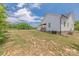 Exterior side view of a white home with a large yard, perfect for outdoor activities and enjoying the surroundings at 1134 Fincher Rd, Fort Lawn, SC 29714