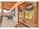 Inviting front porch with double doors adorned with decorative wreaths and comfortable seating at 1134 Fincher Rd, Fort Lawn, SC 29714