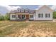Charming front exterior featuring black shutters, a covered front porch, and a welcoming wood front door at 1134 Fincher Rd, Fort Lawn, SC 29714
