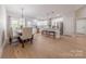Bright kitchen with stainless appliances, white cabinets, an island with bar seating, and adjacent dining area at 1134 Fincher Rd, Fort Lawn, SC 29714