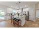 Bright kitchen with white cabinetry, stainless appliances, an eat-in island, and access to the balcony at 1134 Fincher Rd, Fort Lawn, SC 29714