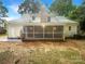 View of the backyard featuring a screened porch, patio, and well-maintained lawn at 1212 Beechdale Dr, Charlotte, NC 28212
