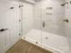 Modern bathroom with glass shower and white marble tile at 1212 Beechdale Dr, Charlotte, NC 28212