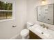 Bathroom featuring a marble vanity, modern fixtures, and natural light from the window at 1212 Beechdale Dr, Charlotte, NC 28212
