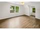 Bright bedroom with large windows, hardwood floors, and neutral paint at 1212 Beechdale Dr, Charlotte, NC 28212