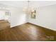 Elegant dining room featuring hardwood floors, a modern chandelier, and ample natural light at 1212 Beechdale Dr, Charlotte, NC 28212