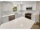Updated kitchen with white cabinets, quartz countertops, and stainless steel appliances at 1212 Beechdale Dr, Charlotte, NC 28212
