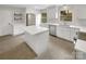 Modern kitchen featuring white cabinets, stainless steel appliances, a center island, and bright lighting at 1212 Beechdale Dr, Charlotte, NC 28212