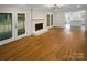 Bright living room with hardwood floors, a fireplace, and french doors at 1212 Beechdale Dr, Charlotte, NC 28212
