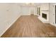Spacious living room with hardwood floors and white painted brick fireplace at 1212 Beechdale Dr, Charlotte, NC 28212