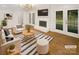 Bright living room featuring hardwood floors, fireplace, and French doors to the backyard at 1212 Beechdale Dr, Charlotte, NC 28212