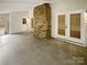 Enclosed patio featuring tile floor, access doors, and brick fireplace at 1212 Beechdale Dr, Charlotte, NC 28212