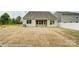 View of the home's rear exterior, complemented by a spacious, grassy backyard at 125 S Prestwick Way # 41, Mooresville, NC 28115