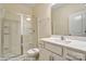 Bathroom featuring a vanity with white cabinets and a shower with glass doors at 125 S Prestwick Way # 41, Mooresville, NC 28115