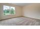 Cozy bedroom with a large window offering a view of the outdoors at 125 S Prestwick Way # 41, Mooresville, NC 28115