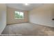 Carpeted bedroom with a window offering natural light and neutral-toned walls at 125 S Prestwick Way # 41, Mooresville, NC 28115