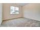 Cozy bedroom with carpet flooring, a window, and neutral-colored walls at 125 S Prestwick Way # 41, Mooresville, NC 28115