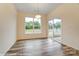 Bright dining area featuring wood floors, a modern light fixture, and sliding glass doors to a patio at 125 S Prestwick Way # 41, Mooresville, NC 28115