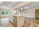 Open kitchen with island, stainless steel dishwasher, and views to the backyard at 125 S Prestwick Way # 41, Mooresville, NC 28115