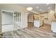 Open-concept kitchen with white cabinets, an island, stainless steel appliances, and access to a screened-in porch at 125 S Prestwick Way # 41, Mooresville, NC 28115
