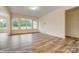Bright living room with large windows overlooking backyard and new laminate flooring throughout at 125 S Prestwick Way # 41, Mooresville, NC 28115