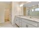 Main bathroom featuring double sinks, granite counters, and a large shower with tile surround at 125 S Prestwick Way # 41, Mooresville, NC 28115