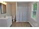 Well-lit bathroom boasts modern fixtures, including a vanity, toilet, and shower with decorative curtain at 1277 Eden Dr # 18, Chester, SC 29706
