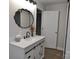 Modern bathroom boasts a decorative mirror, white vanity with sliding doors, and a sleek black faucet at 1277 Eden Dr # 18, Chester, SC 29706