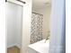 Bright bathroom featuring a shower with a decorative curtain and a view of the closet at 1277 Eden Dr # 18, Chester, SC 29706