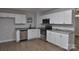 This kitchen features wooden floors, stainless steel appliances, and a granite countertop at 1277 Eden Dr # 18, Chester, SC 29706