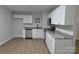 This kitchen features wooden floors, stainless steel appliances, and a granite countertop at 1277 Eden Dr # 18, Chester, SC 29706