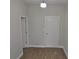 Empty room featuring neutral walls, wood-look floors, and two white paneled doors at 1277 Eden Dr # 18, Chester, SC 29706