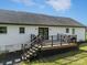 A back view of the house featuring a porch with backyard access and black railings at 130 Johnson Dairy Rd, Rockwell, NC 28138