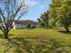 Expansive backyard featuring lush lawn, mature trees, and a deck, ideal for outdoor activities and relaxation at 130 Johnson Dairy Rd, Rockwell, NC 28138