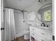 Bathroom featuring a shower, toilet, vanity, and cabinet storage, complemented by wood-look flooring at 130 Johnson Dairy Rd, Rockwell, NC 28138