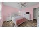 Bedroom featuring a bed, dresser with a TV, ceiling fan, and pastel pink walls at 130 Johnson Dairy Rd, Rockwell, NC 28138