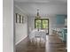 Bright dining area features wood floors, white table setting, and a stylish chandelier at 130 Johnson Dairy Rd, Rockwell, NC 28138