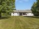 Beautiful home with a well-maintained lawn, featuring a covered front porch at 130 Johnson Dairy Rd, Rockwell, NC 28138