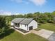 Aerial view of home with well-manicured lawn, black accents, and mature landscaping at 130 Johnson Dairy Rd, Rockwell, NC 28138