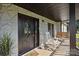 Charming front porch featuring a swing, rocking chair, and decorative front door at 130 Johnson Dairy Rd, Rockwell, NC 28138