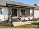Inviting front porch with stone facade, porch swing and well maintained landscaping at 130 Johnson Dairy Rd, Rockwell, NC 28138